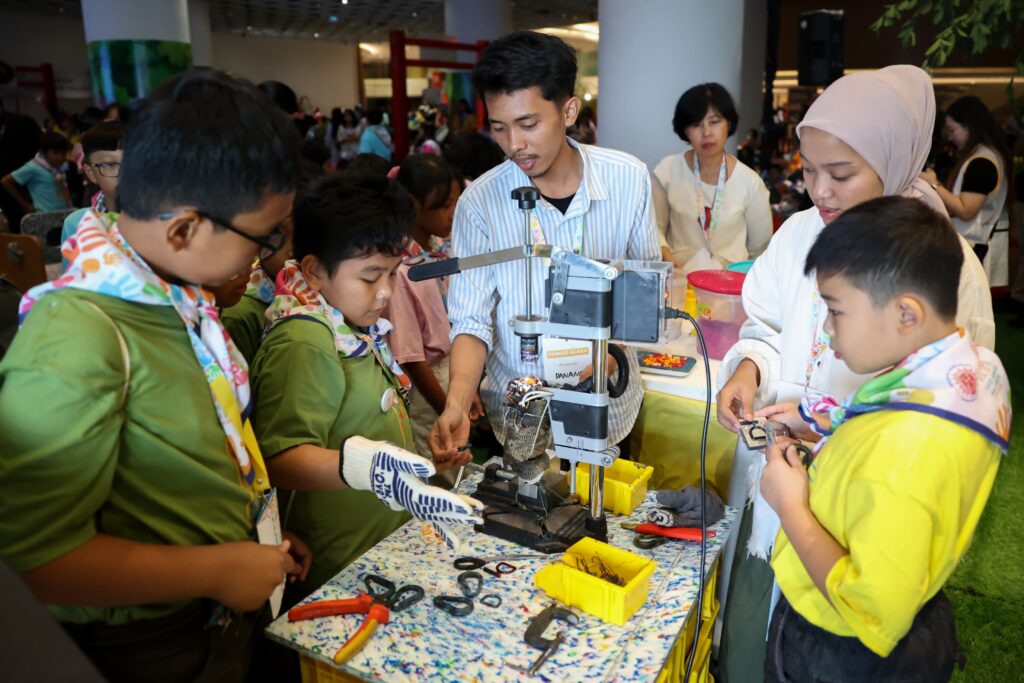 Children learning how to recycle plastic